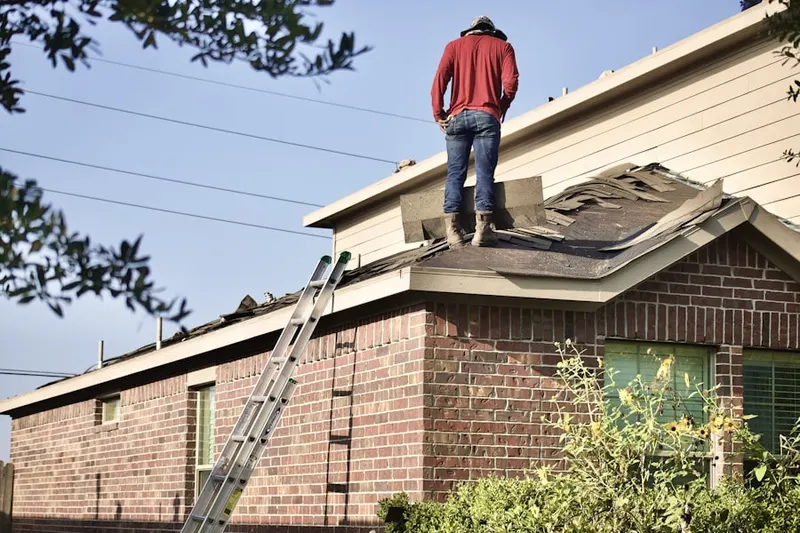 Professional roofer working on a residential roof in East Atlantic Beach